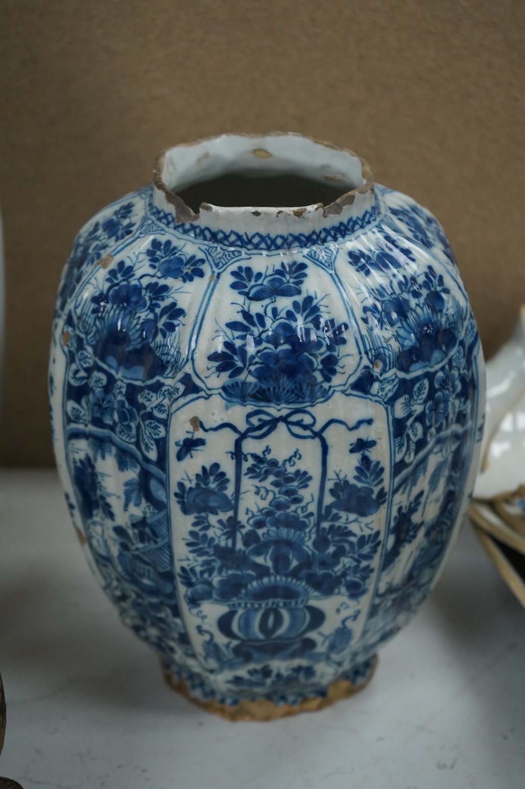 A late 17th century Delft faceted blue and white vase, by Lambartus van Eenhorn, and another broken similar, 29cm high (a.f.)